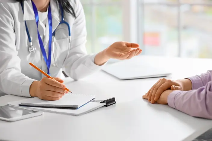 Doctor consulting with a patient during a medical appointment at a clinic