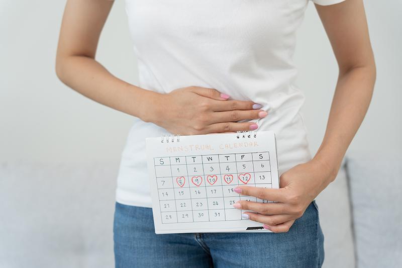A woman experiencing menstrual-related discomfort