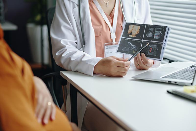 Expectant mother reviewing ultrasound scan with her obstetrician at a prenatal appointment