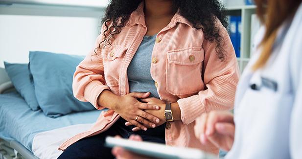 A woman consulting a medical professional in a clinical sett